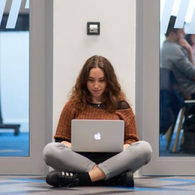 student-sitting-floor-laptop.jpg