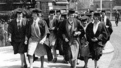 leading women early female students walking